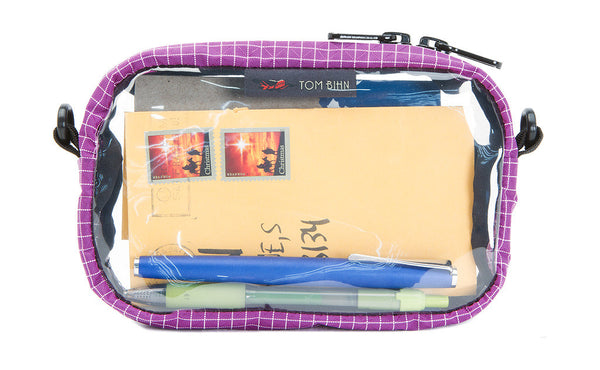 An Ultraviolet purple with white grid pattern (Halcyon) 3D Clear Organizer Cube filled with sundries.